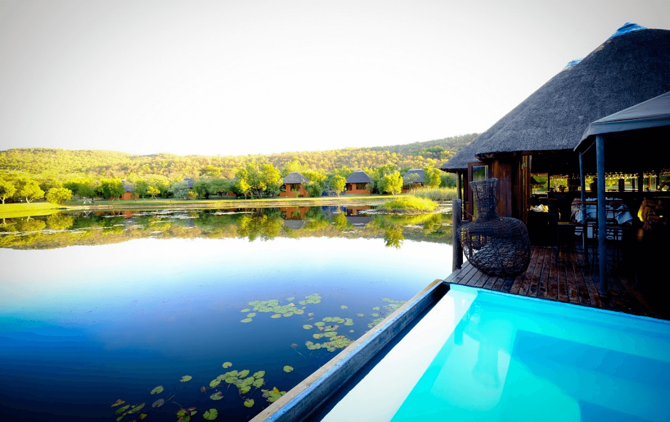 View of the pool and dam at Intundla Game Lodge & Bush Spa